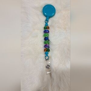 Mardi Glow Beaded Badge Reel – Iridescent Carnival Colors